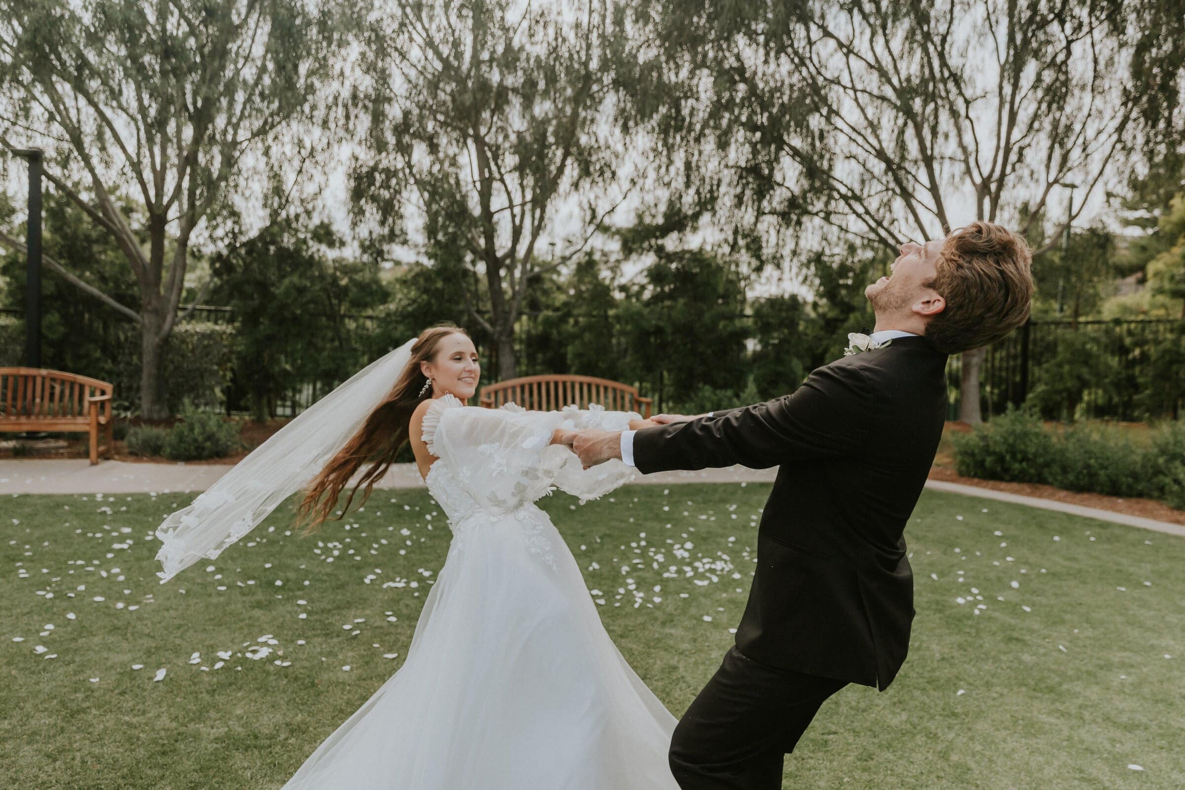 Aleck and Irelyn spinning on the lawn, her veil flying