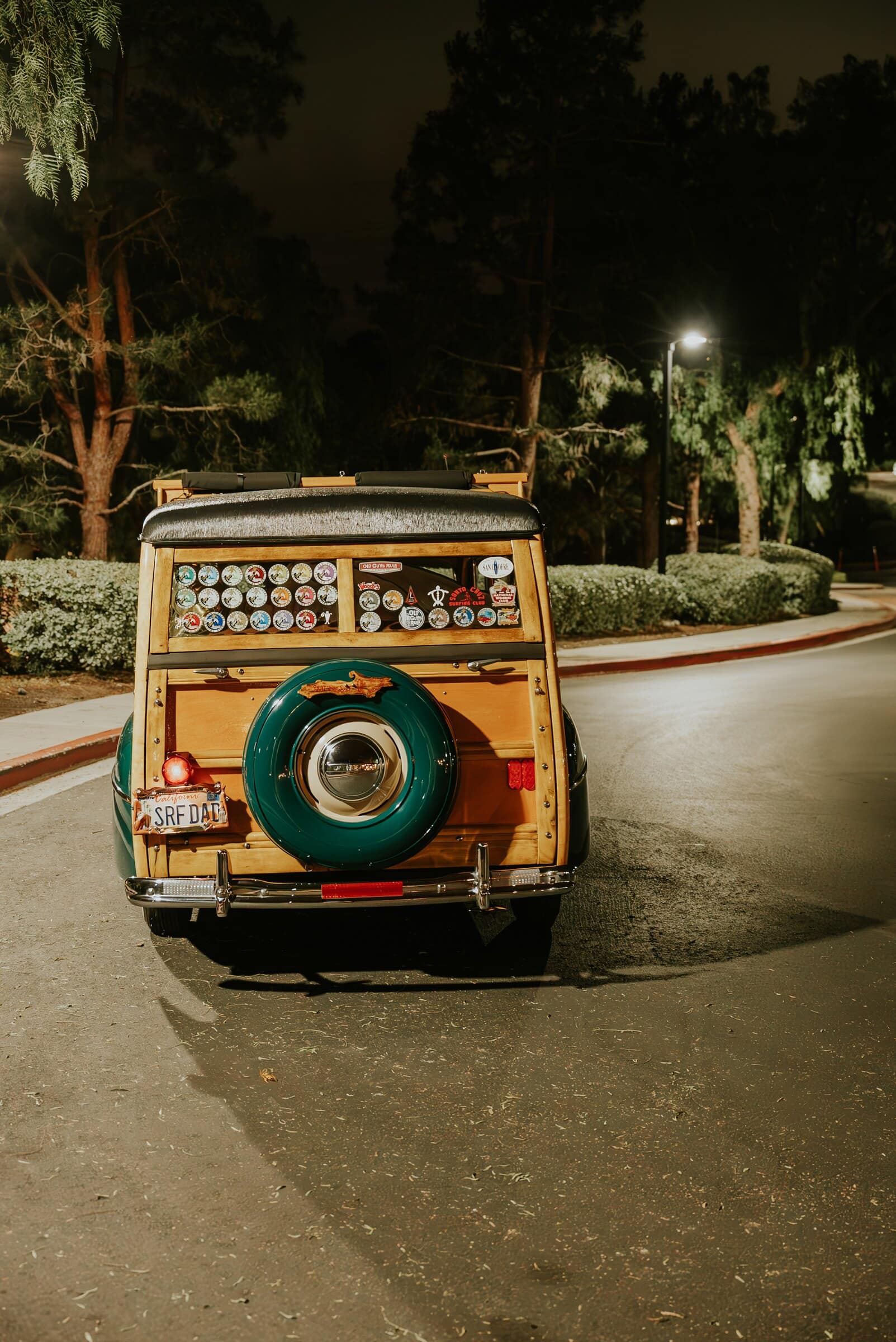 A wood-paneled vintage car waiting for the send-off at night