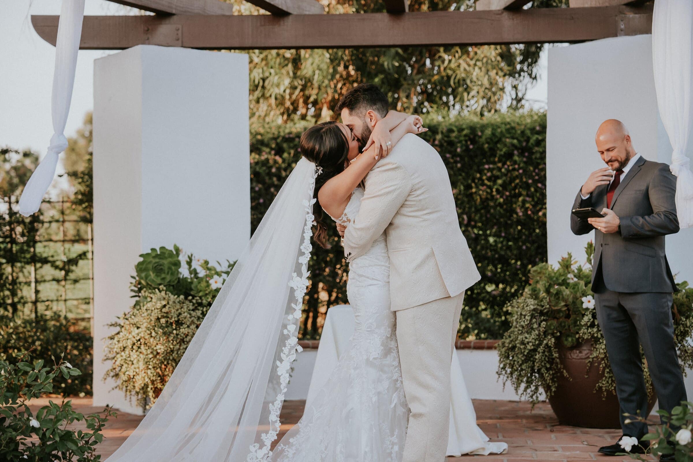 Ariana and Dom's first kiss under the white pergola