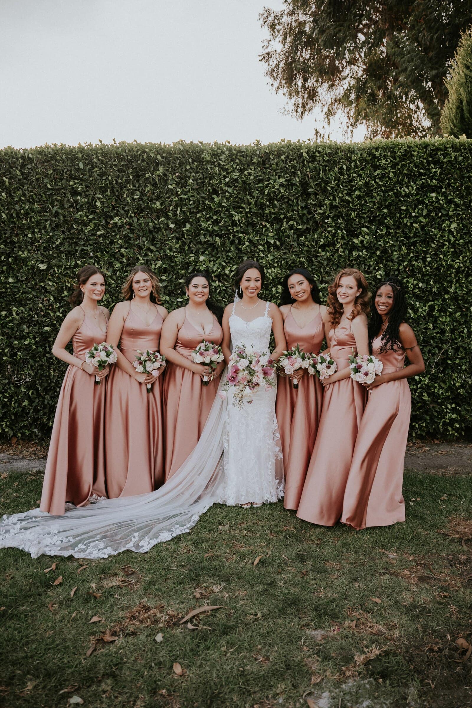 Ariana with her bridesmaids in blush satin