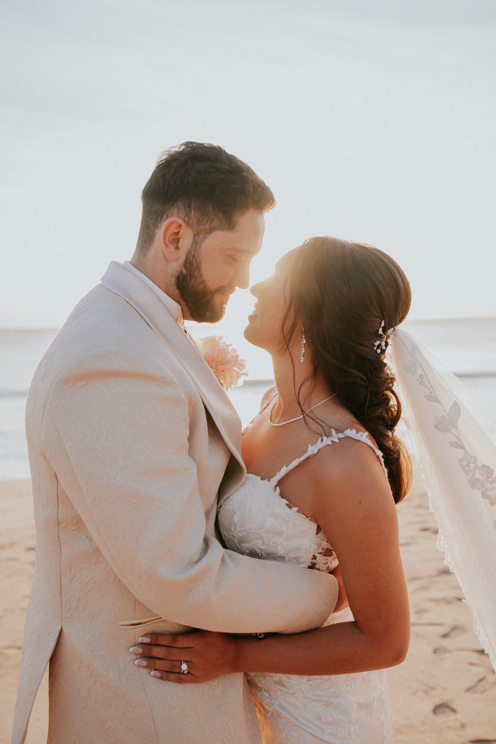 Dom and Ariana face to face on the beach at sunset