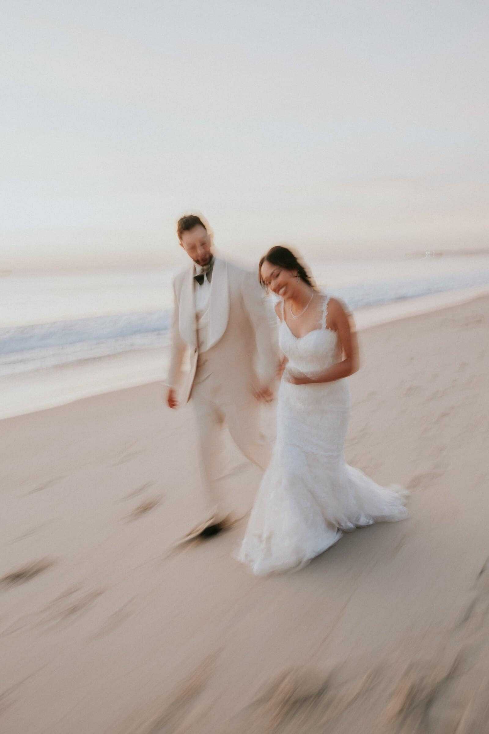 Ariana and Dom walking along the sand