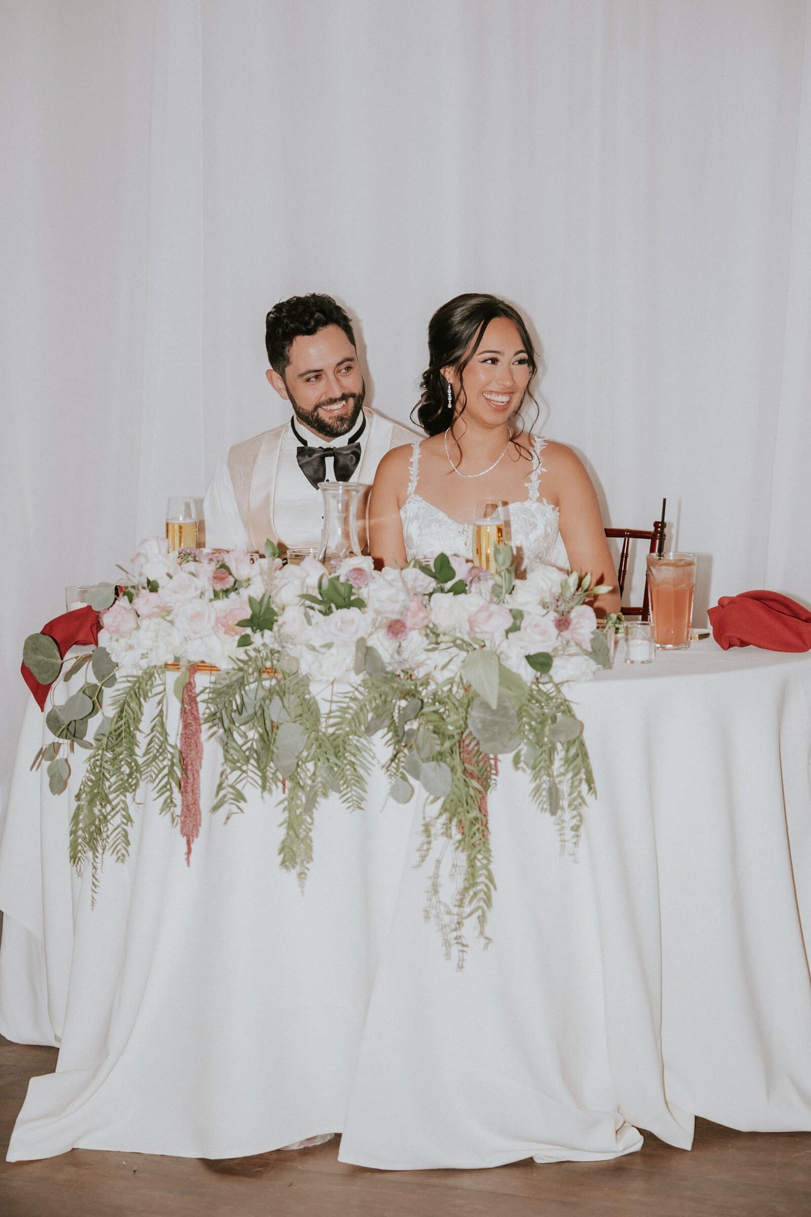 Ariana and Dom laughing at the sweetheart table