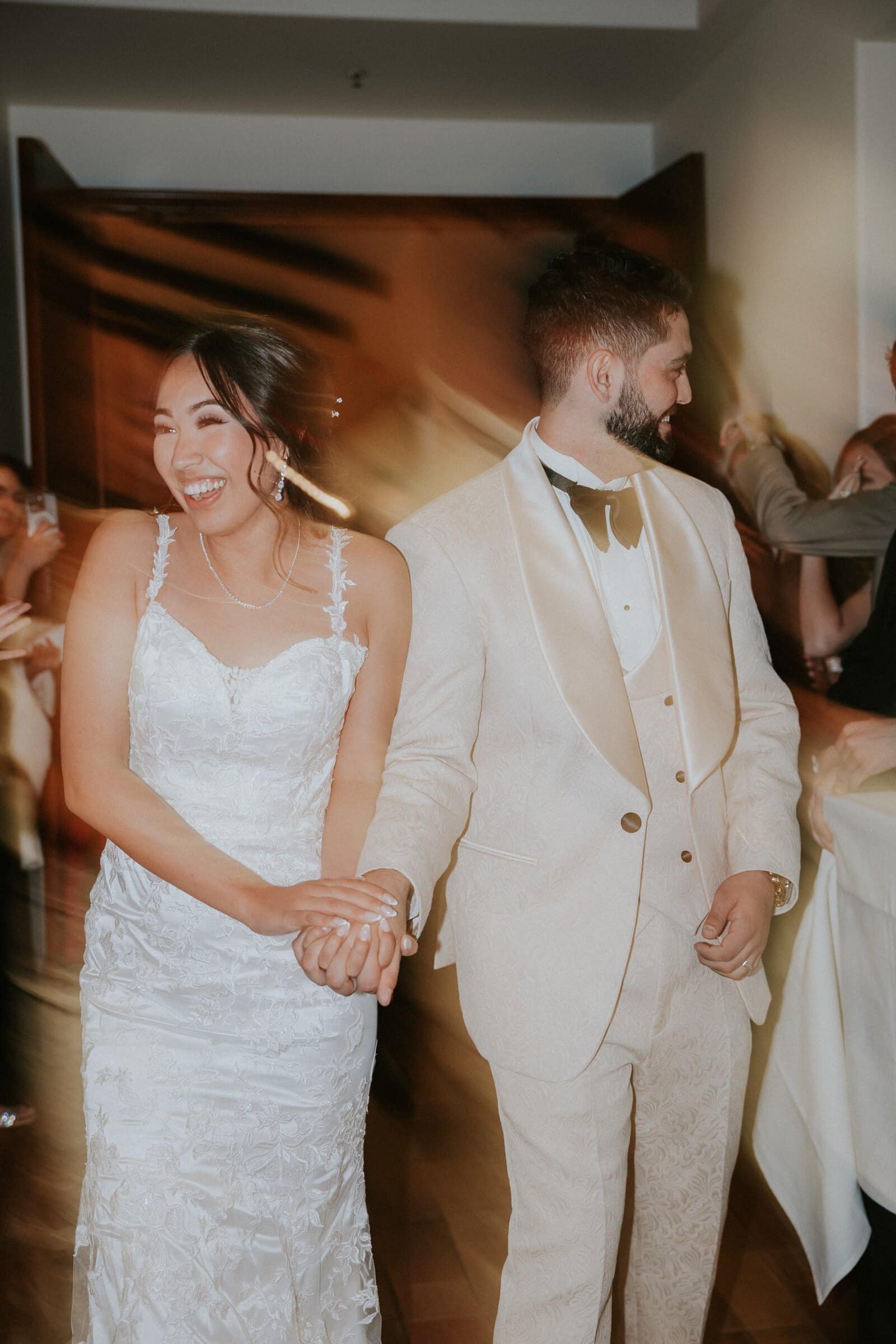 Ariana and Dom dancing in the warm reception light