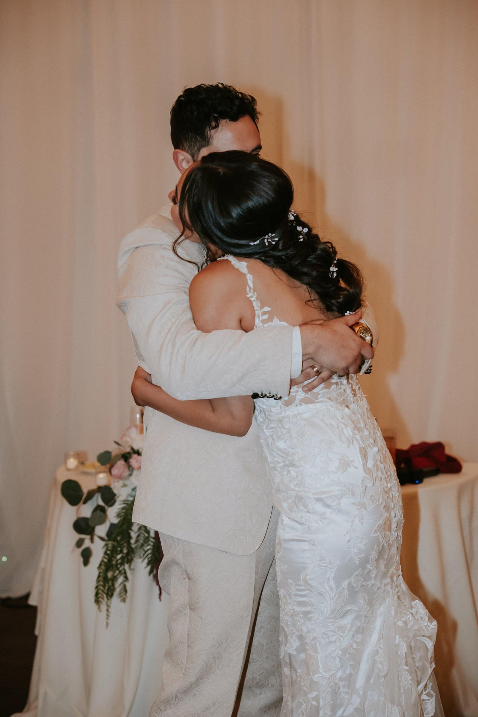 Ariana and Dom holding each other at the reception