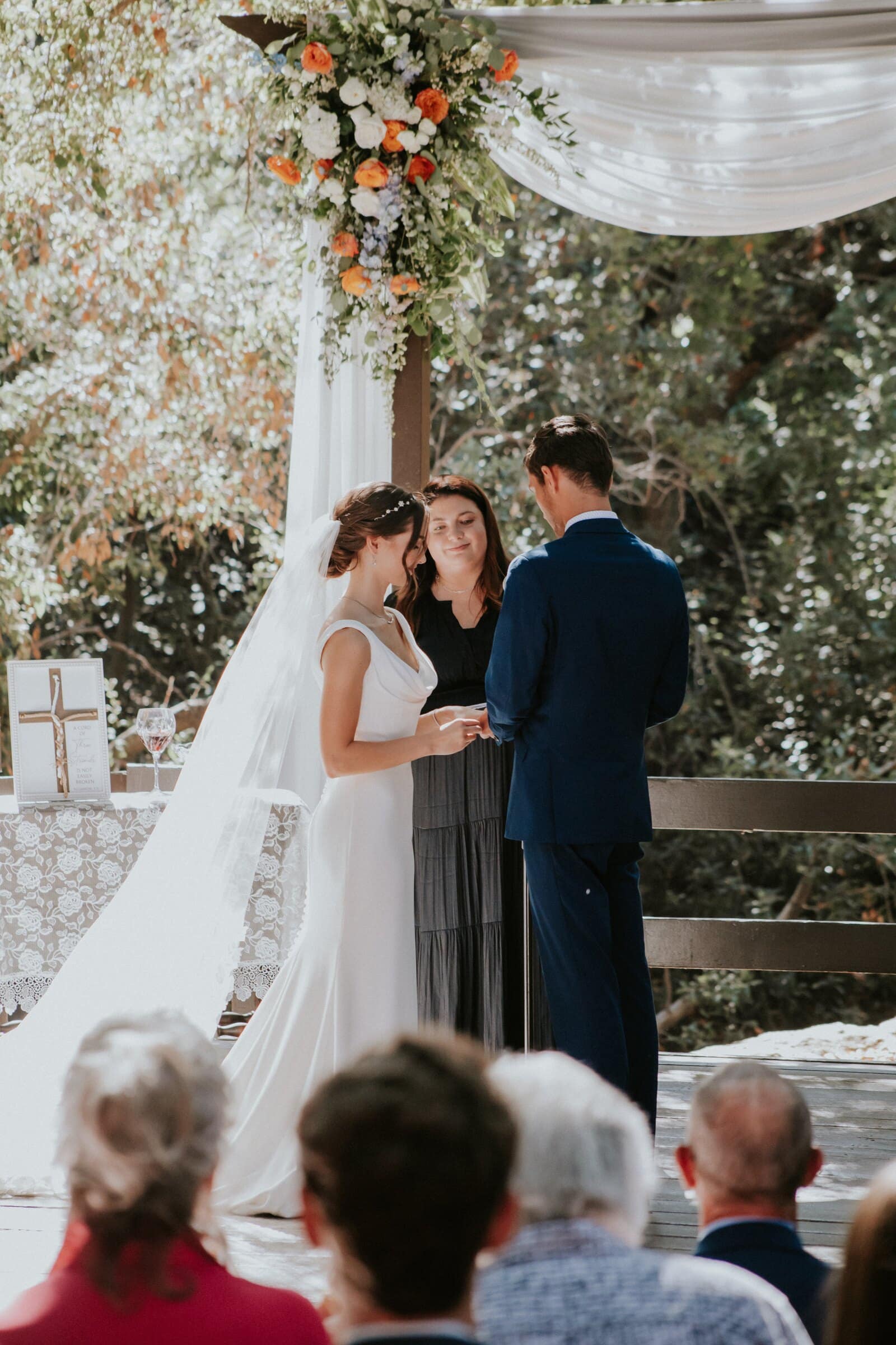 Claire and Bryce at the altar as the officiant speaks