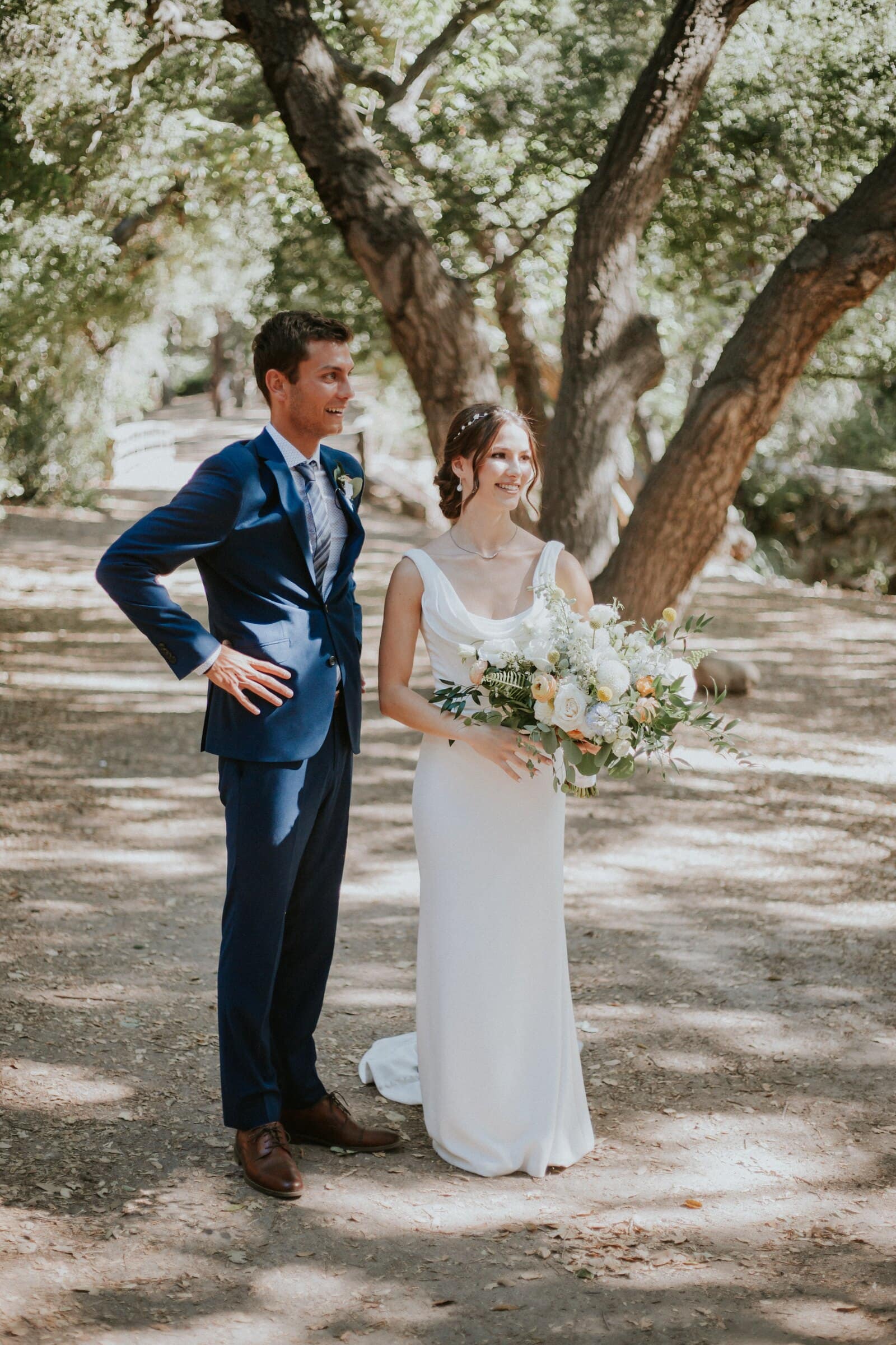 Bryce and Claire standing together in a grove of oaks