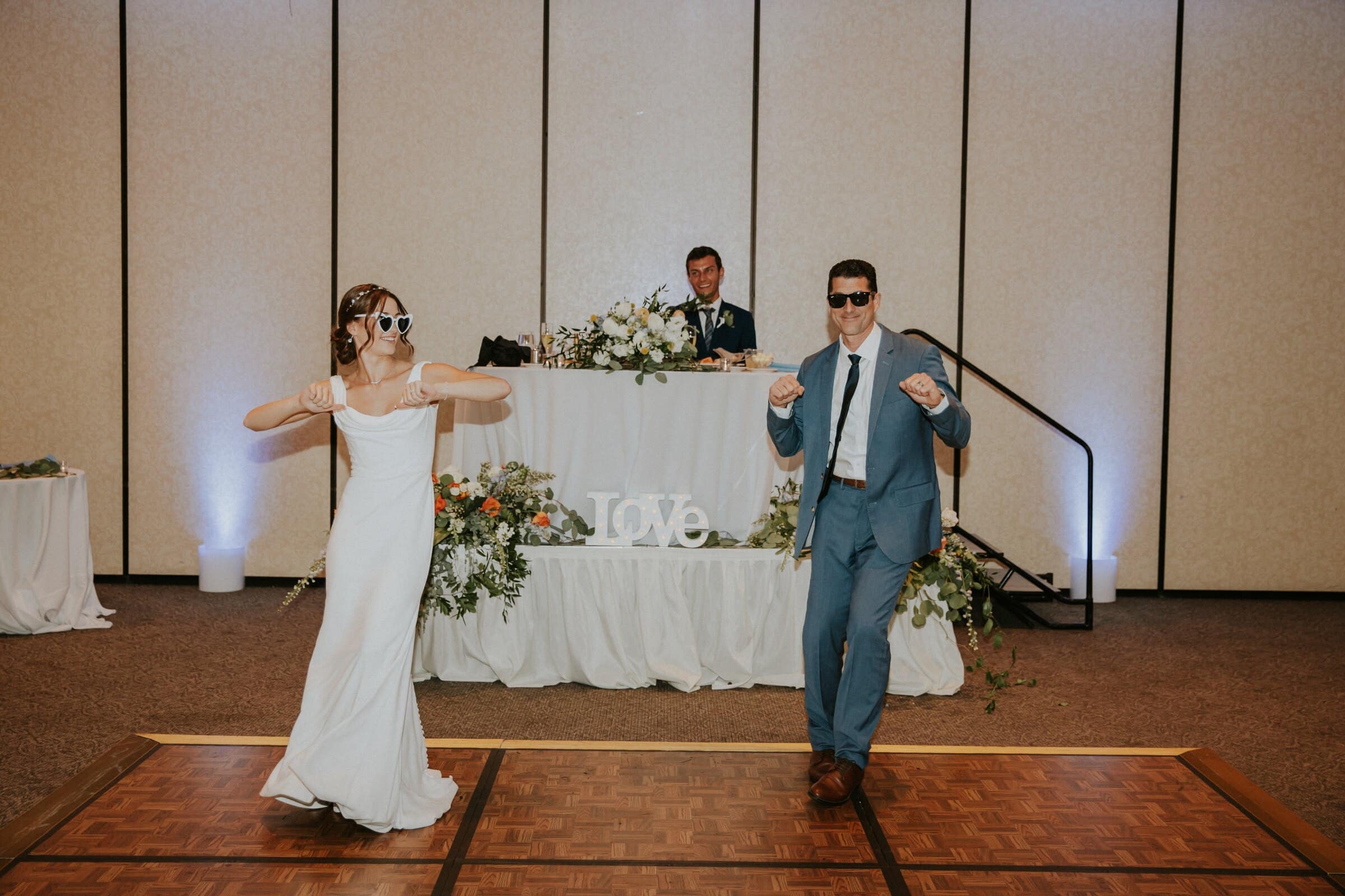 Claire and Bryce dancing in sunglasses