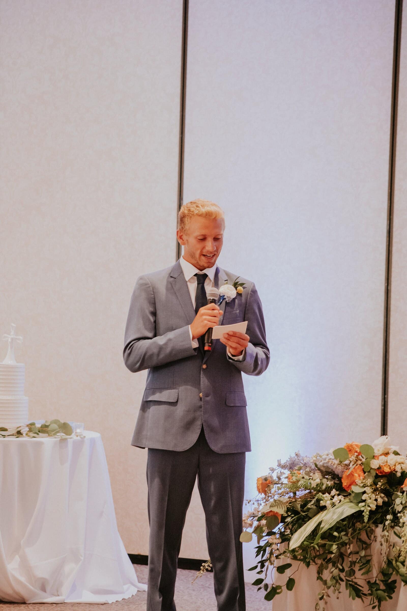 A groomsman giving a toast