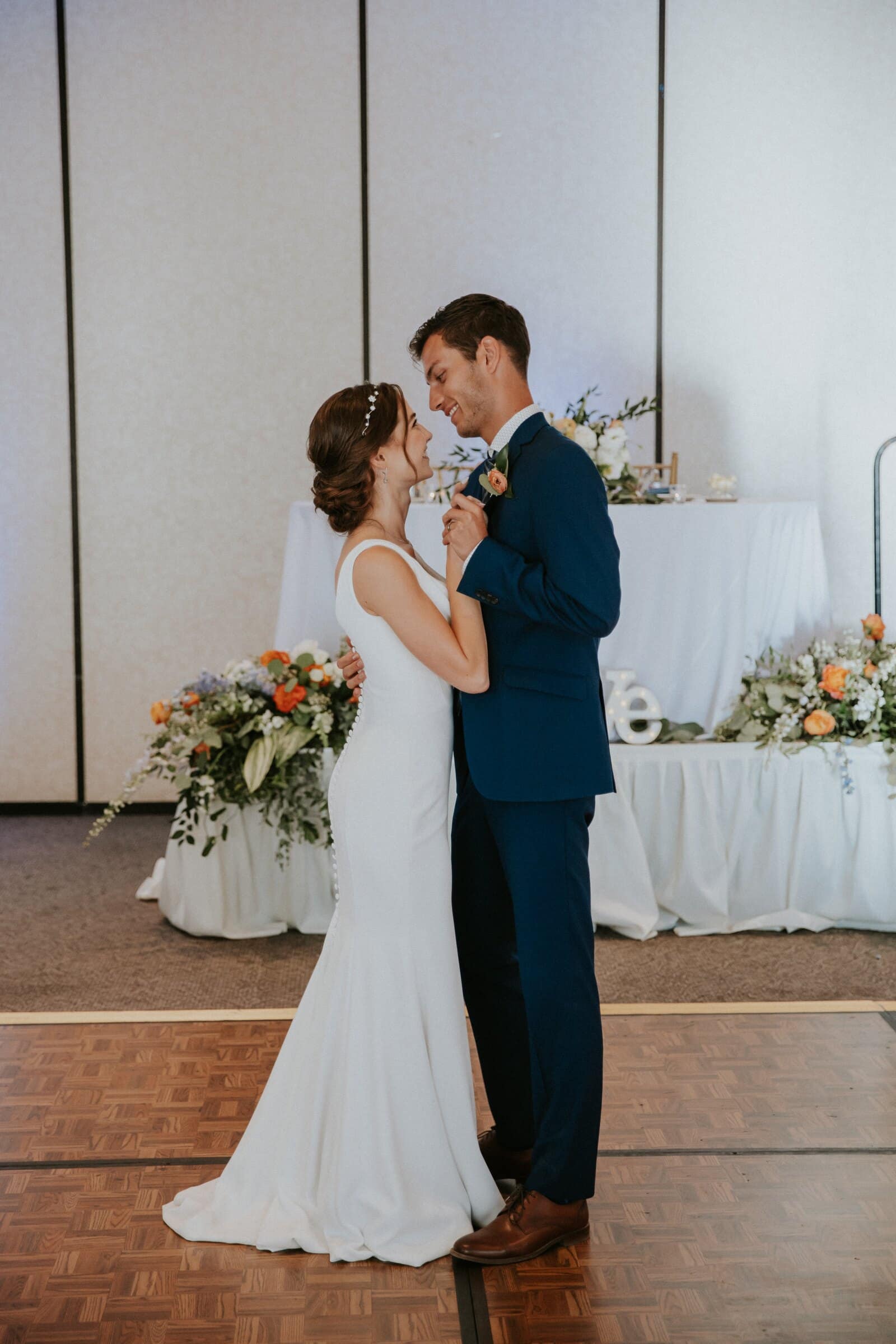 Claire and Bryce smiling at each other during their first dance