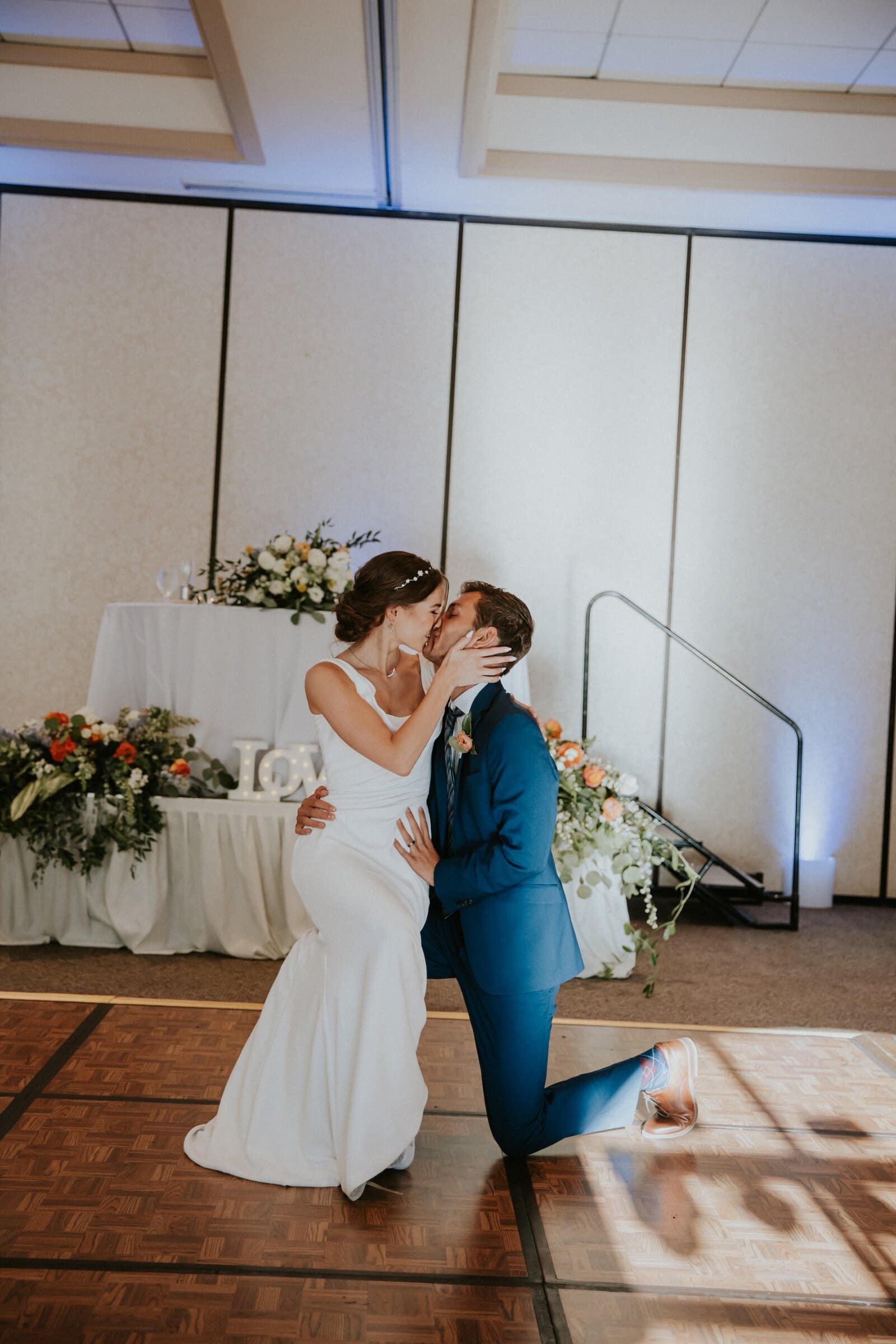 Bryce down on one knee kissing Claire on the dance floor