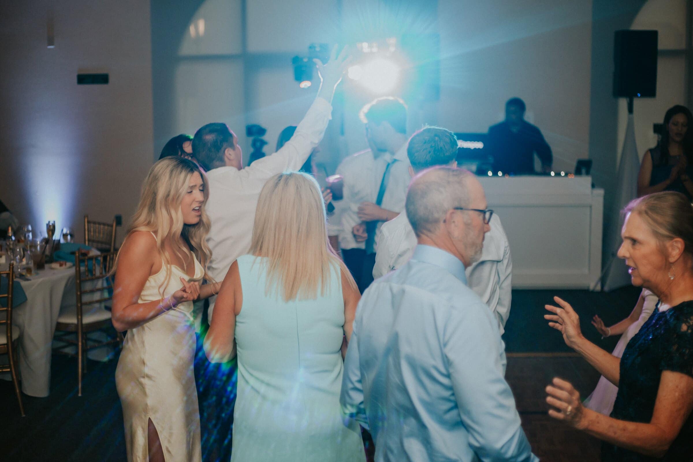 Friends dancing in the glow of the DJ lights