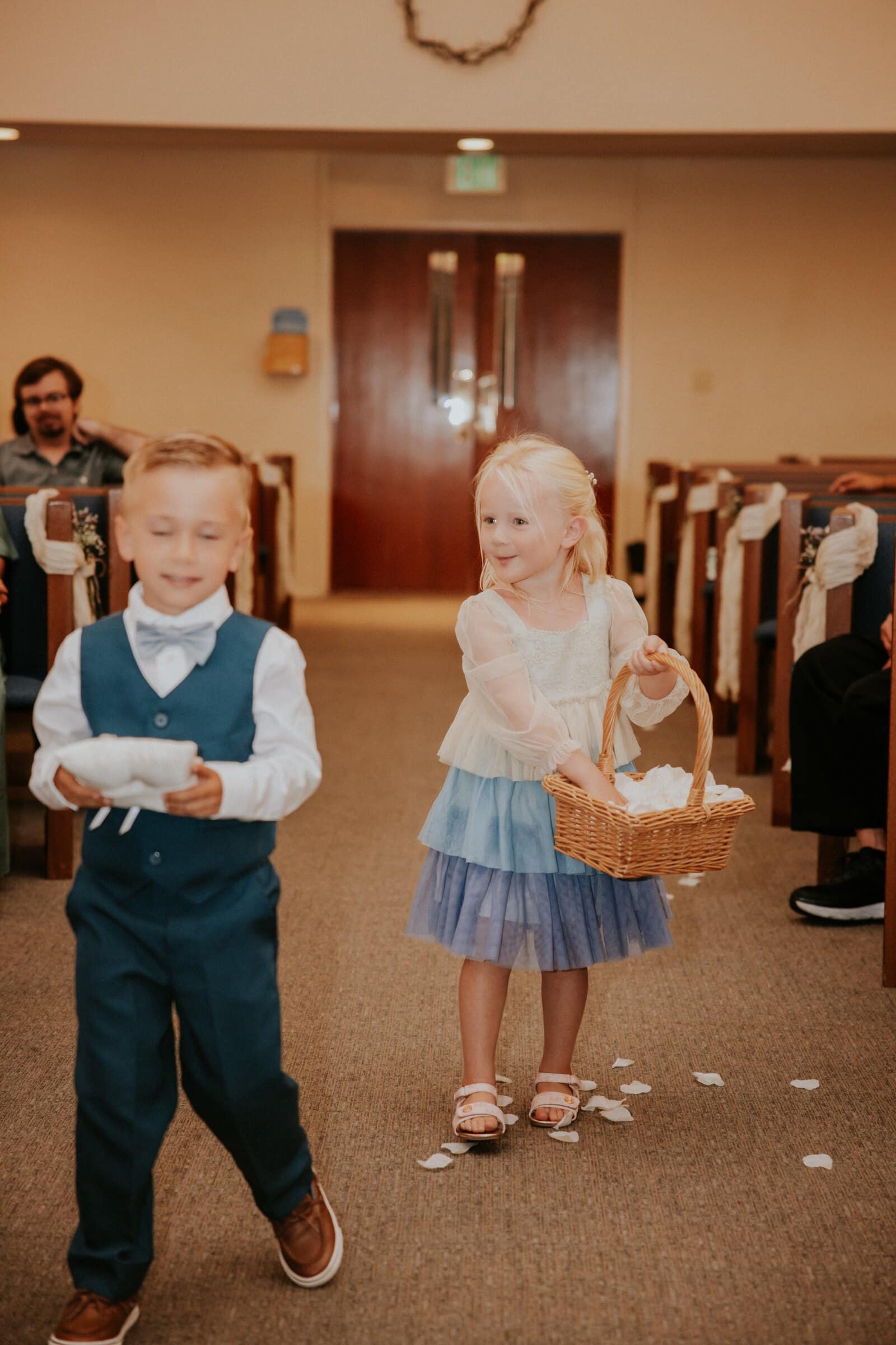 The ring bearer and flower girl coming down the aisle