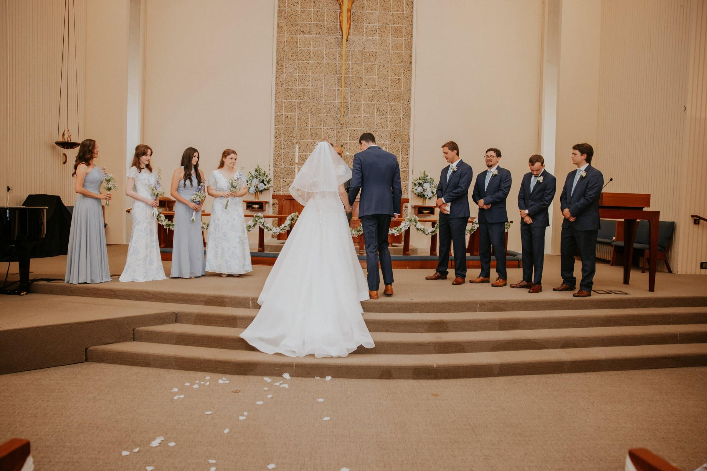 Morgan and Bryce at the front of the church with their wedding party