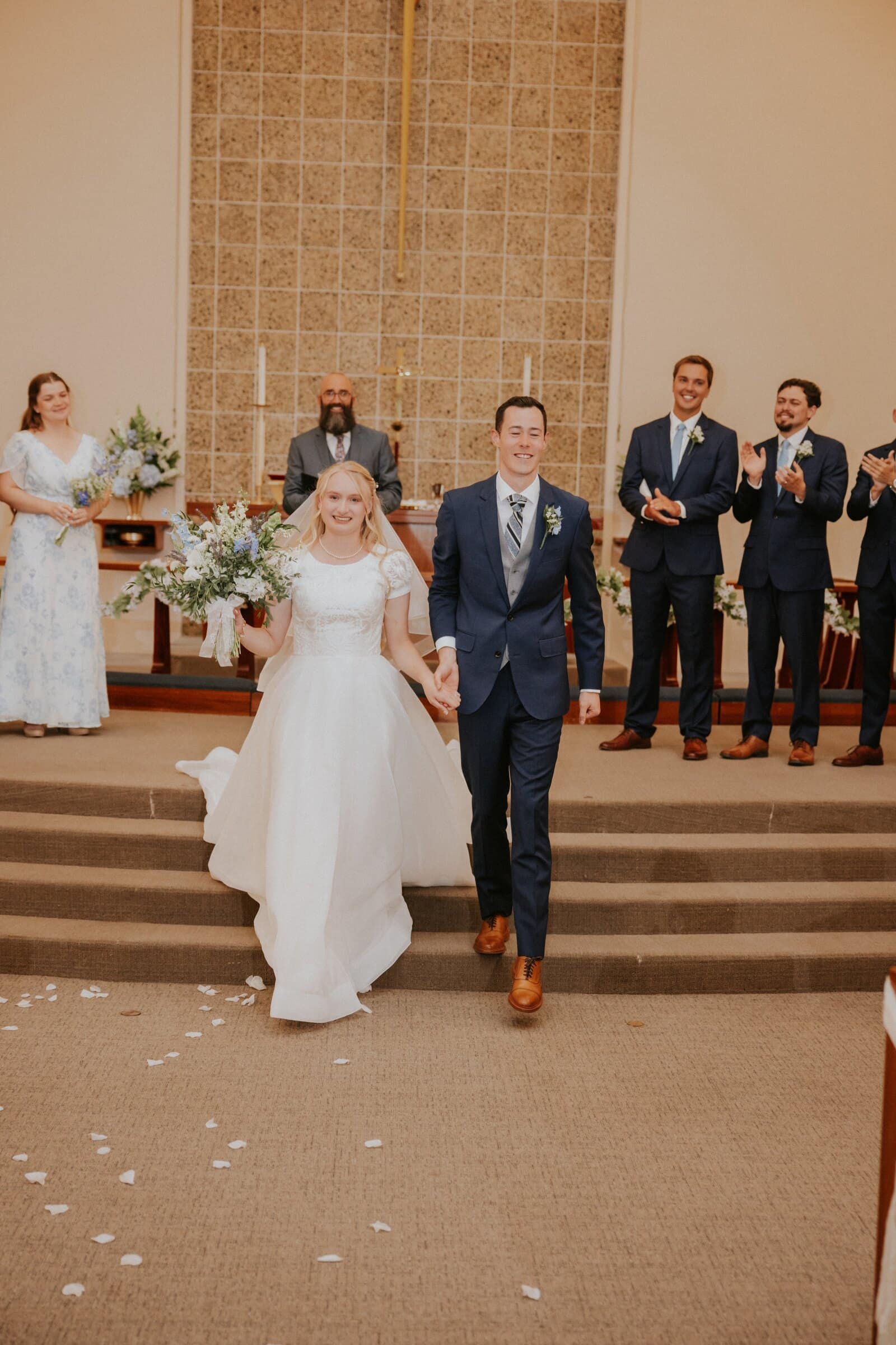 Morgan and Bryce walking back down the aisle as husband and wife