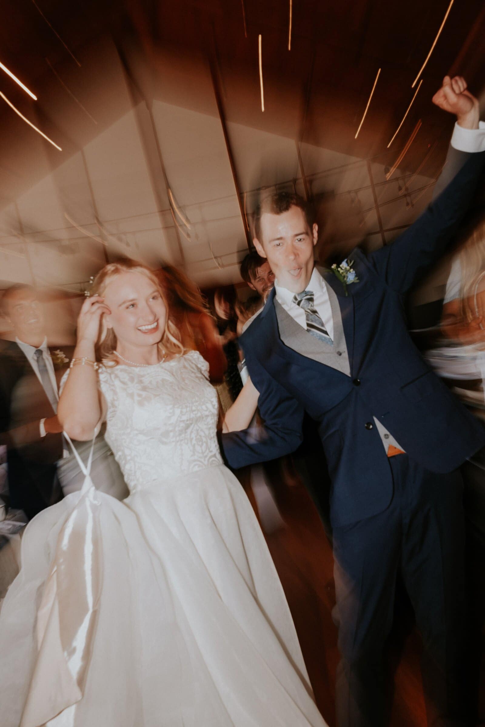 Bryce and Morgan dancing in the middle of the room, the lights streaking