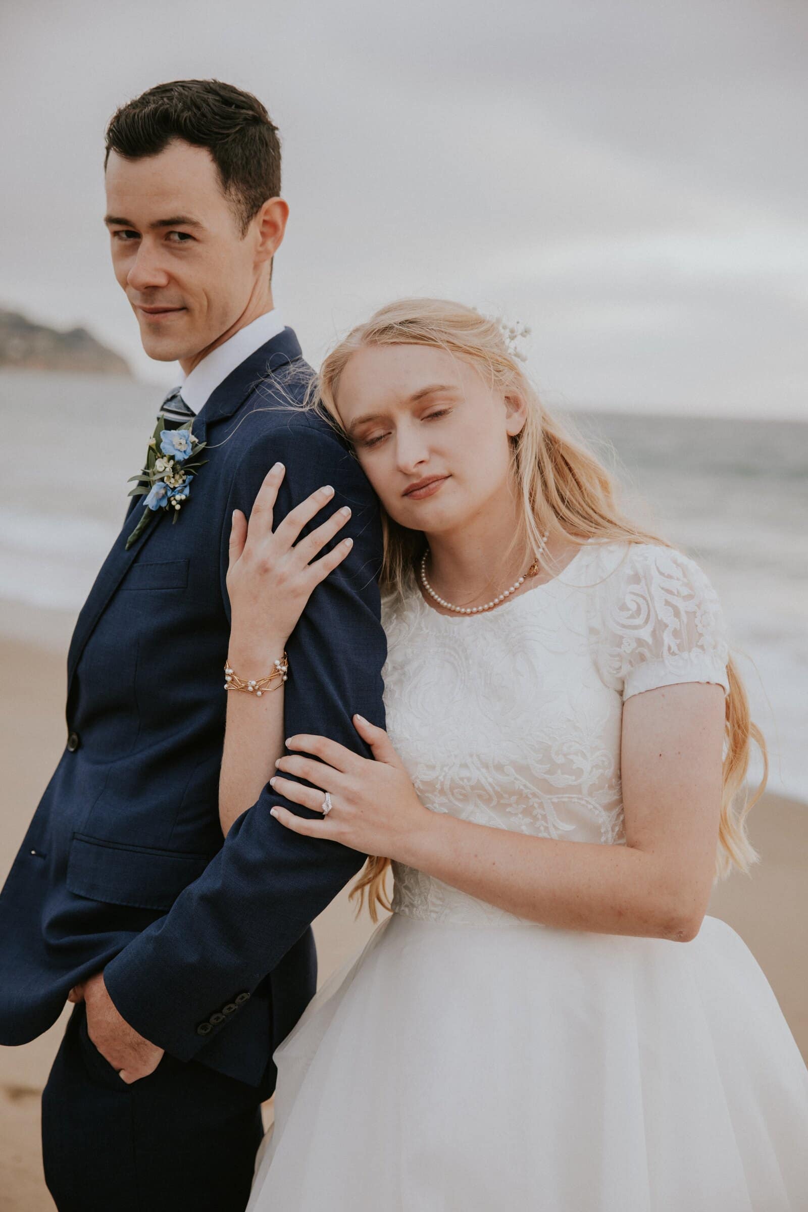 Morgan resting her head on Bryce's shoulder on the beach