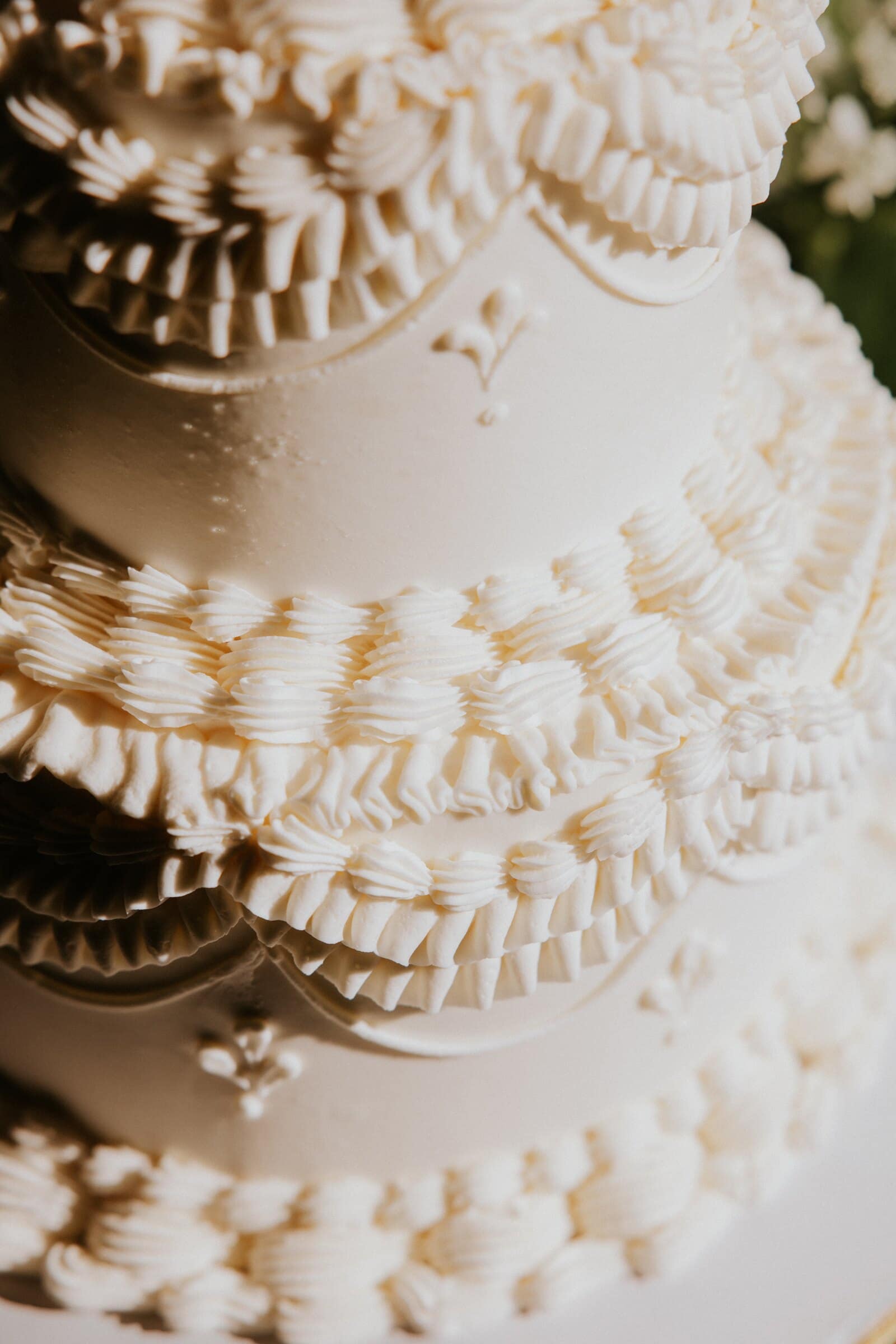 Close-up of the piped white wedding cake
