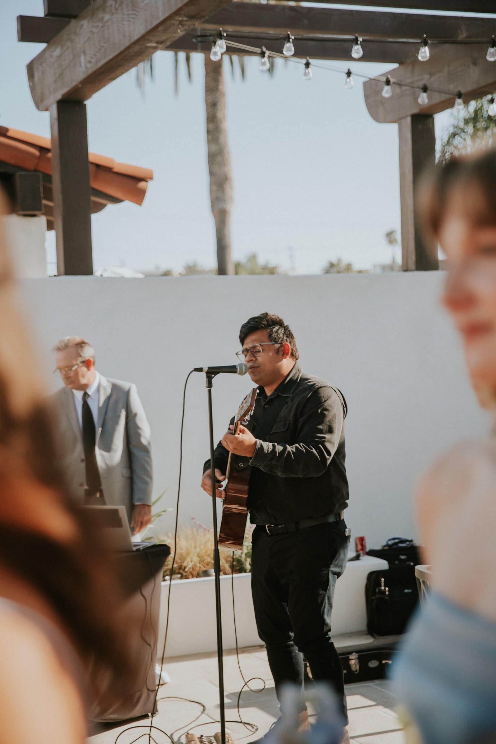A singer with a guitar performing during the ceremony