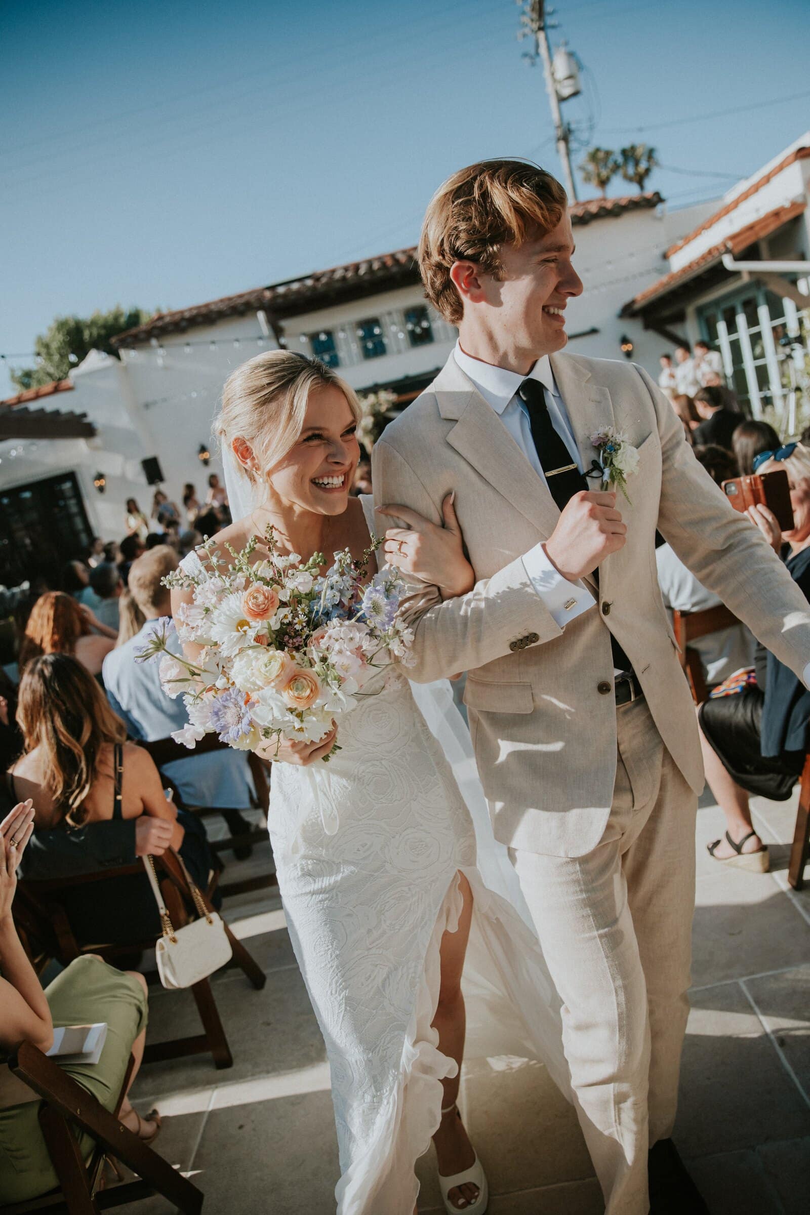 Micah and Leilani walking back up the aisle, laughing