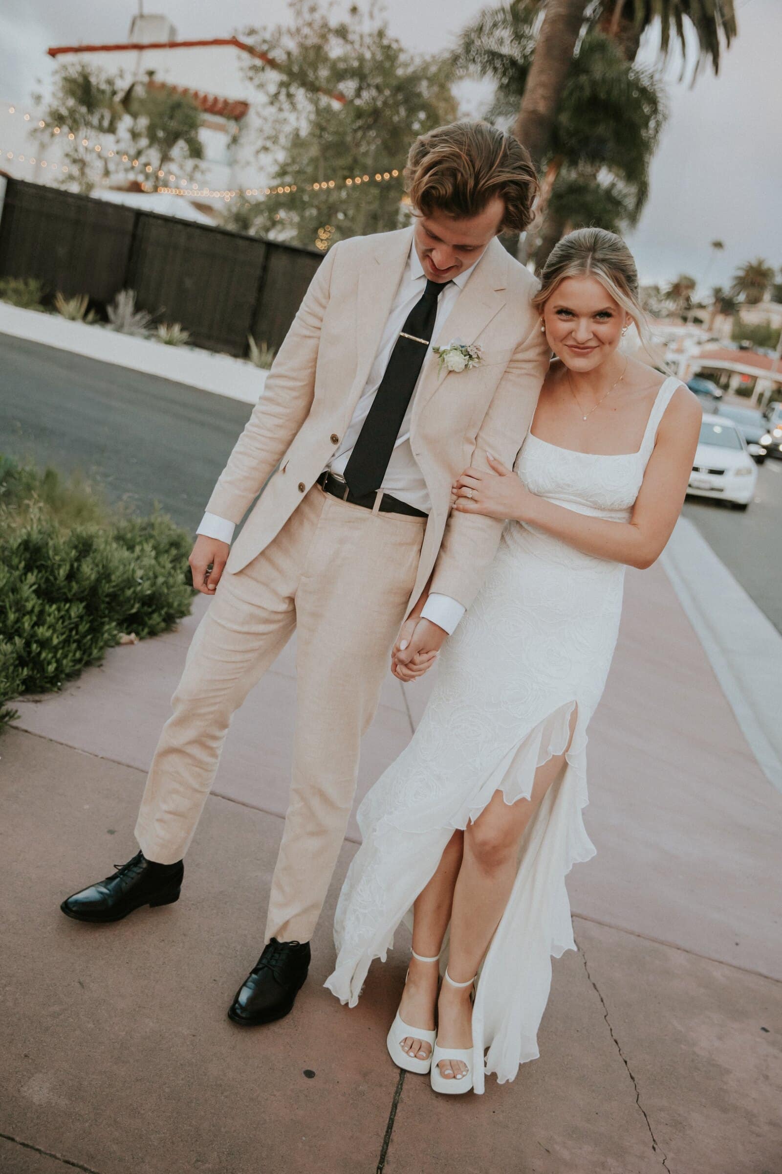 Leilani holding Micah's arm as they walk down the sidewalk