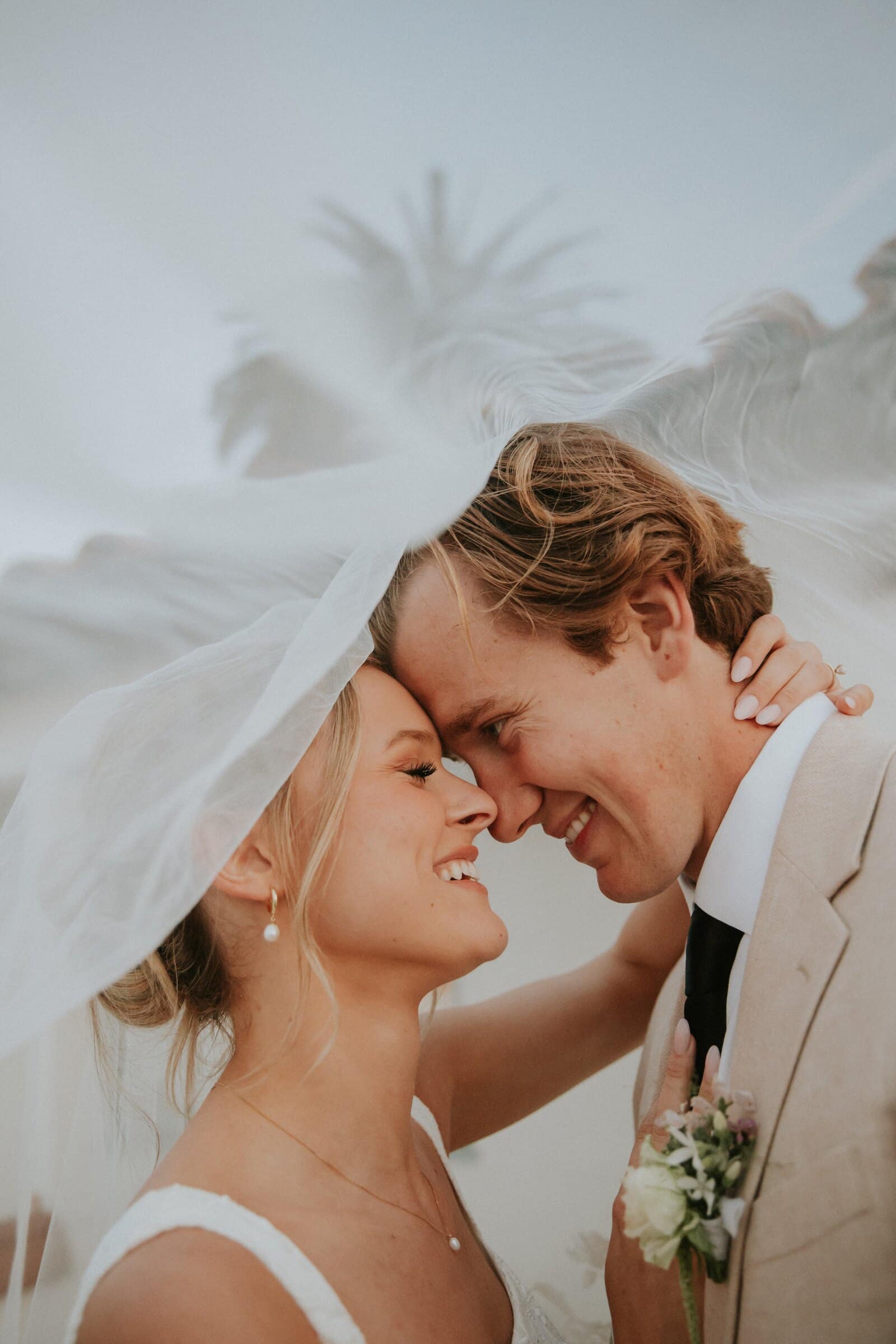 Leilani and Micah forehead to forehead under her veil